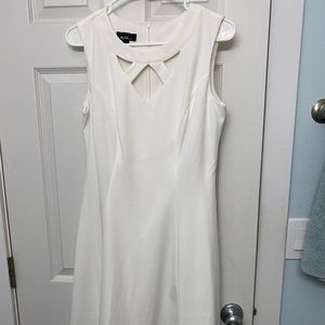 White sleeveless dress with geometric neckline cutouts